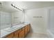 Bright bathroom featuring double sinks and a large mirror, combining functionality and elegance at 18239 N 40Th St # 107, Phoenix, AZ 85032