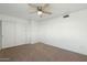 An empty bedroom featuring carpet floors, a ceiling fan, and large closet at 18239 N 40Th St # 107, Phoenix, AZ 85032