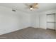 A bright bedroom features a ceiling fan and double door closet providing ample storage space at 18239 N 40Th St # 107, Phoenix, AZ 85032