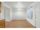 A dining area with a modern chandelier fixture and hardwood floors, adjacent to the kitchen at 18239 N 40Th St # 107, Phoenix, AZ 85032