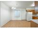 Bright dining area featuring hardwood floors, a modern chandelier, and a window at 18239 N 40Th St # 107, Phoenix, AZ 85032