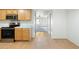 An eat-in kitchen with stainless steel appliances and wood cabinetry, and a view into the living room at 18239 N 40Th St # 107, Phoenix, AZ 85032