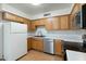 Functional kitchen with wood cabinets, stainless steel appliances, and plenty of counter space at 18239 N 40Th St # 107, Phoenix, AZ 85032