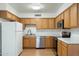 Well-equipped kitchen with stainless steel appliances, wood cabinets, and ample counter space at 18239 N 40Th St # 107, Phoenix, AZ 85032