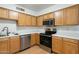 An eat-in kitchen with stainless steel appliances and wood cabinetry at 18239 N 40Th St # 107, Phoenix, AZ 85032