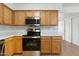 Updated kitchen with stainless steel appliances, wood cabinets, and modern fixtures at 18239 N 40Th St # 107, Phoenix, AZ 85032