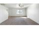 Inviting living room with ceiling fan, neutral carpet, and a large window providing natural light at 18239 N 40Th St # 107, Phoenix, AZ 85032