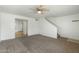Bright living room with neutral carpet, ceiling fan, and staircase to the upper level at 18239 N 40Th St # 107, Phoenix, AZ 85032