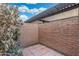 Private patio with brick walls and tiled floor, offering a cozy and secluded outdoor retreat at 18239 N 40Th St # 107, Phoenix, AZ 85032