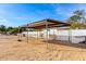 Rustic barn featuring sturdy metal frame perfect for storage or livestock, surrounded by fenced yard at 19412 W Clarendon Ave, Litchfield Park, AZ 85340