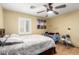 Comfortable bedroom featuring a ceiling fan, plantation shutters, and calming wall decor at 19412 W Clarendon Ave, Litchfield Park, AZ 85340