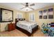 Cozy bedroom with ceiling fan, plantation shutters, light walls, and a queen bed at 19412 W Clarendon Ave, Litchfield Park, AZ 85340