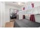 Bedroom featuring a mirrored closet, ceiling fan, and a cozy bunk bed at 19412 W Clarendon Ave, Litchfield Park, AZ 85340
