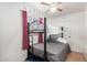 Cozy bedroom featuring a bunk bed, ceiling fan, and natural light from the window at 19412 W Clarendon Ave, Litchfield Park, AZ 85340