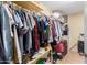Walk-in closet with ample hanging space, shelving, and storage solutions for organization at 19412 W Clarendon Ave, Litchfield Park, AZ 85340