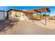 Exterior shot of the house showcasing a covered parking area and gravel landscaping at 19412 W Clarendon Ave, Litchfield Park, AZ 85340
