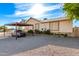 Ranch style home featuring a desert landscape and covered parking area at 19412 W Clarendon Ave, Litchfield Park, AZ 85340
