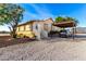 Ranch style home featuring a desert landscape and covered parking at 19412 W Clarendon Ave, Litchfield Park, AZ 85340