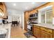 Kitchen with stainless steel appliances, wood cabinetry and granite countertops at 19412 W Clarendon Ave, Litchfield Park, AZ 85340