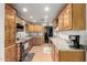 Kitchen features wood cabinetry, laminate countertops, and stainless steel appliances at 19412 W Clarendon Ave, Litchfield Park, AZ 85340