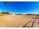 Large, open plot of land showcasing its size and potential for various uses with clear blue sky above at 19412 W Clarendon Ave, Litchfield Park, AZ 85340