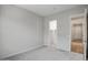 Bright bedroom with neutral carpet, walk-in closet, and en-suite bathroom entrance at 20085 W Campbell Ave, Buckeye, AZ 85396