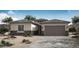 Charming single-story home featuring stone accents, a neutral color palette, and a two-car garage at 20085 W Campbell Ave, Buckeye, AZ 85396