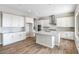 Well-lit kitchen with a large center island, stainless steel appliances, and ample cabinet space at 20085 W Campbell Ave, Buckeye, AZ 85396