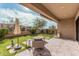 Inviting backyard boasts green turf, a fire pit, and covered patio perfect for outdoor entertaining at 2065 N Red Clf, Mesa, AZ 85207