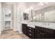 Bright bathroom featuring dual sinks, wood flooring, and a separate walk-in closet at 2065 N Red Clf, Mesa, AZ 85207