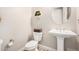 Clean powder room features a pedestal sink, toilet, and decorative wall accents at 2065 N Red Clf, Mesa, AZ 85207