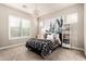 Cozy bedroom with plush carpet, a stylish chandelier, and a comfortable bed with decorative pillows and blanket at 2065 N Red Clf, Mesa, AZ 85207