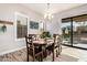 Bright dining area features a wooden table with seating for six and sliding glass doors to the backyard at 2065 N Red Clf, Mesa, AZ 85207