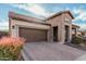 Inviting home featuring a brick facade, a paved driveway, and a professionally landscaped front yard at 2065 N Red Clf, Mesa, AZ 85207