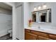 Nicely decorated bathroom with tub, wood vanity, modern mirror, and attractive lighting at 2146 W Isabella Ave # 215, Mesa, AZ 85202