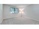 Cozy bedroom with carpet, natural light from a window, and a floor lamp at 2146 W Isabella Ave # 215, Mesa, AZ 85202