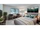 Bedroom boasts a plush bed, two sitting chairs, a modern rug, and great natural light at 2146 W Isabella Ave # 215, Mesa, AZ 85202