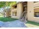 A close view of the condo's exterior with stairs leading up to the units at 2146 W Isabella Ave # 215, Mesa, AZ 85202