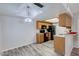 Bright kitchen featuring wood cabinets, black appliances, and stylish wood grain flooring at 2146 W Isabella Ave # 215, Mesa, AZ 85202