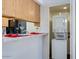 Kitchen with breakfast bar and adjacent laundry featuring stacked washer and dryer at 2146 W Isabella Ave # 215, Mesa, AZ 85202