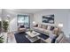 Well-lit living room featuring stylish furniture and a sliding glass door to a balcony at 2146 W Isabella Ave # 215, Mesa, AZ 85202