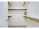 Spacious walk-in closet features multiple shelves and rods for optimal storage at 2146 W Isabella Ave # 215, Mesa, AZ 85202