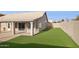 This home's backyard features a covered patio and artificial grass lawn, perfect for entertaining and relaxing at 30663 N 44Th St, Cave Creek, AZ 85331