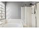 Bathroom featuring a tub, shower stall, and a window for natural light at 30663 N 44Th St, Cave Creek, AZ 85331