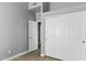 This bedroom features modern gray walls, wood look flooring, a closet, and a second door to another room at 30663 N 44Th St, Cave Creek, AZ 85331