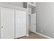 This bedroom features modern gray walls, wood look flooring, a closet, and a second door to another room at 30663 N 44Th St, Cave Creek, AZ 85331