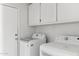 This laundry room features modern white cabinets, an LG washer and dryer, and a white door on the left at 30663 N 44Th St, Cave Creek, AZ 85331