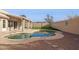 This home's backyard features a sparkling swimming pool and an artificial grass lawn, perfect for entertaining and relaxing at 30663 N 44Th St, Cave Creek, AZ 85331