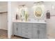 A bathroom with a double vanity, light grey cabinetry, quartz countertops, and decorative flowers at 3536 N Arabella --, Mesa, AZ 85215