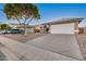 View of the home's garage and driveway, showcasing the tile roof and desert landscaping at 3536 N Arabella --, Mesa, AZ 85215